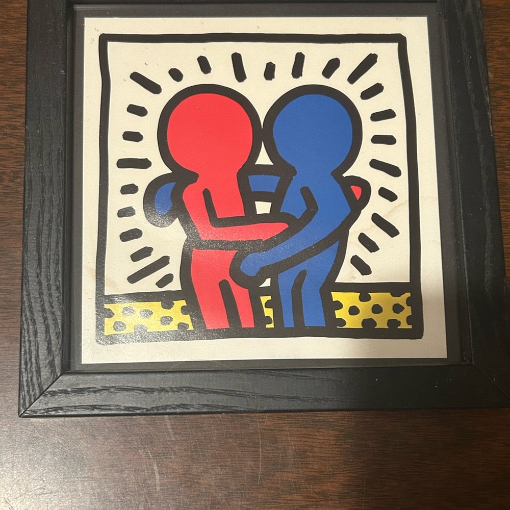 framed print of the iconic "Best Buddies" logo designed by artist Keith Haring.